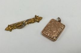A rectangular gold locket engraved with flowers an