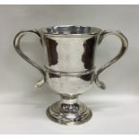 A Georgian silver two handled loving cup on spread