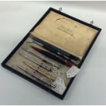 A box containing Morden and other silver pencils.