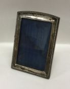 A rectangular silver picture frame with gadroon ri