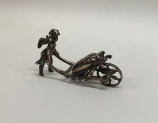 An unusual miniature silver model of a cherub push