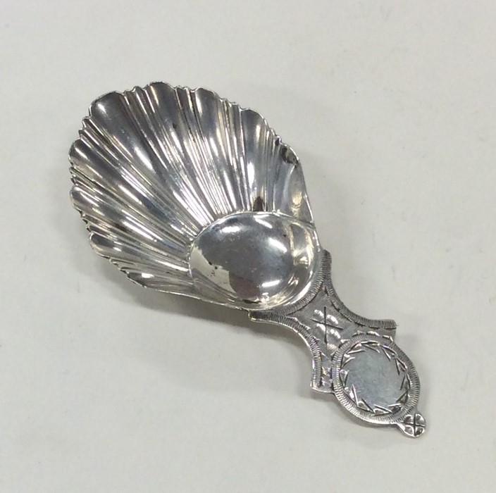 An attractive silver bright cut caddy spoon with f