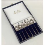 A boxed set of six silver nail top coffee spoons.