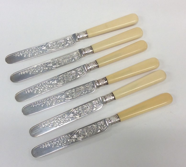 A set of six Edwardian silver engraved tea knives