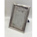 A rectangular engine turned silver picture frame o
