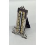 An Edwardian silver thermometer with scroll decora