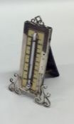 An Edwardian silver thermometer with scroll decora