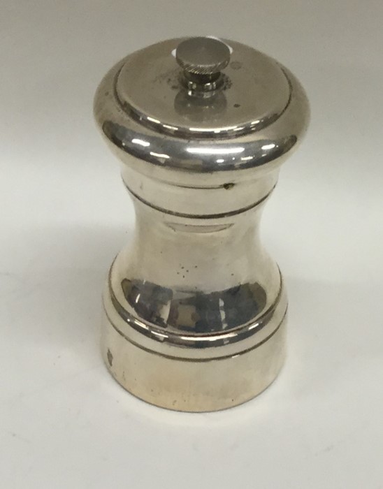 A Sterling silver pepper grinder with screw-on cov