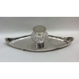 An Edwardian silver canoe shaped inkstand with cut