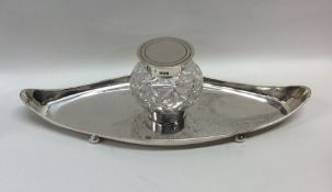 An Edwardian silver canoe shaped inkstand with cut