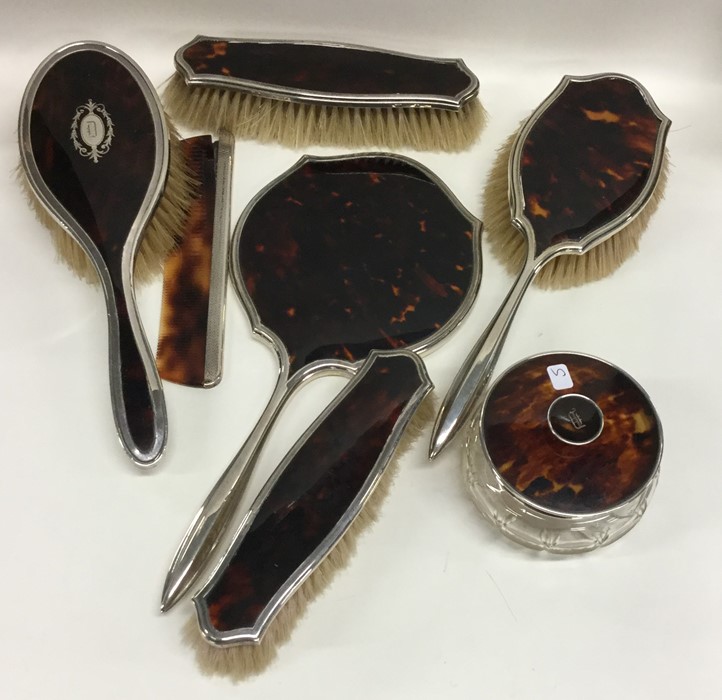 A good silver and tortoiseshell dressing table set