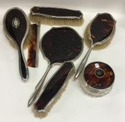 A good silver and tortoiseshell dressing table set