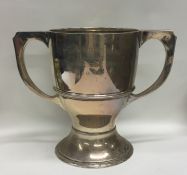 A heavy two handled silver trophy cup of Arts and