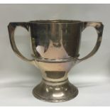 A heavy two handled silver trophy cup of Arts and