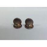 A pair of novelty silver scallop shaped menu holde