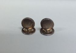 A pair of novelty silver scallop shaped menu holde