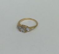 A cubic zirconia three stone ring set in gold. App
