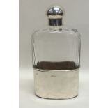 A good glass and silver mounted whisky flask with