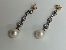 A pair of diamond drop earrings of tapering form w