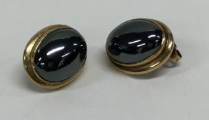 A pair of gold mounted earrings set with large cen