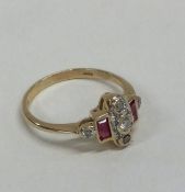 A ruby and diamond ring set in 9 carat mount. Appr