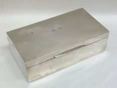A rectangular silver hinged top cigarette box with