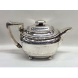 An attractive Georgian silver teapot with gadroon