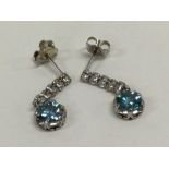 A pair of zircon and diamond six stone earrings in