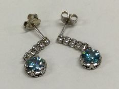 A pair of zircon and diamond six stone earrings in