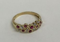 A ruby and diamond modernistic ring in rubover gol