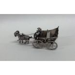 A novelty miniature silver model of a goat and car