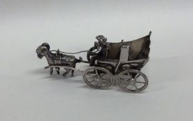 A novelty miniature silver model of a goat and car