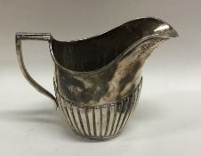 A small half fluted silver cream jug. Sheffield. A