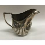 A small half fluted silver cream jug. Sheffield. A