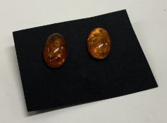 A pair of 9 carat amber mounted ear pendants. Est.