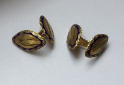 A pair of 14 carat gold and enamelled cuff links.