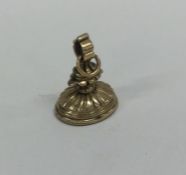 A gold seal with fluted decoration to loop top. Ap