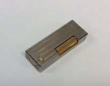 DUNHILL: A stainless steel and gold mounted lighte