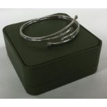 A 9 carat stone set torque bangle contained within