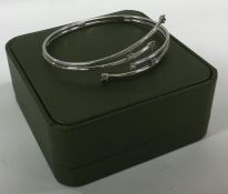 A 9 carat stone set torque bangle contained within