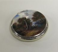 An attractive silver and enamel compact decorated