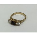 A three stone garnet mounted ring in 9 carat. Appr