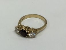 A three stone garnet mounted ring in 9 carat. Appr