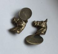 A pair of silver cufflinks mounted with horses. Ap