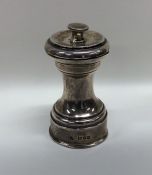 An Edwardian silver pepper grinder of typical form