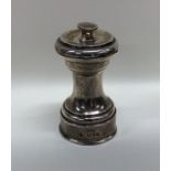 An Edwardian silver pepper grinder of typical form