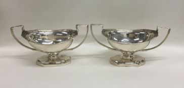 A pair of Georgian silver boat shaped salts reeded