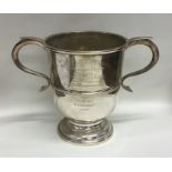 A Georgian style two handled trophy cup on spreadi