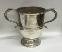 A Georgian style two handled trophy cup on spreadi