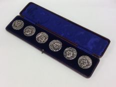 A good quality boxed set of six silver cast button